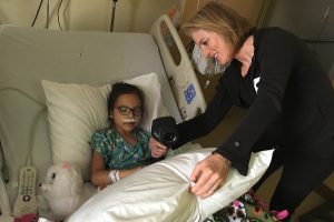 Alterwitz at the hospital with a pediatric patient while the child captures thermal photographs in her hospital room.